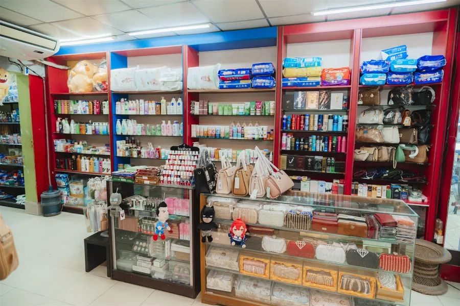 Cosmetics shelves and a glass counter of handbags