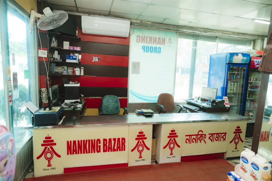 The Nanking Bazar checkout counter with the red Nanking Bazar logo on its front