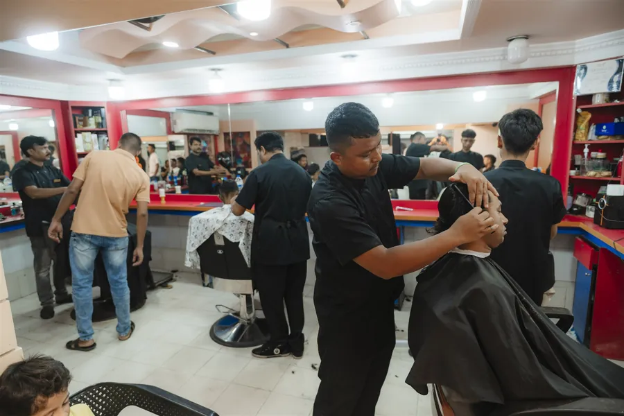 The busy saloon floor with barbers at every chair
